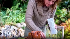 A woman using organic edible flowers.